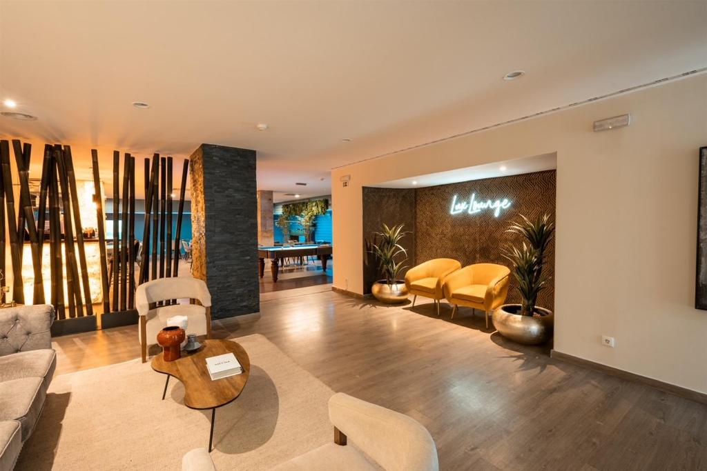 a living room with a couch and chairs and a table at 137 LuxResidence in Lisbon