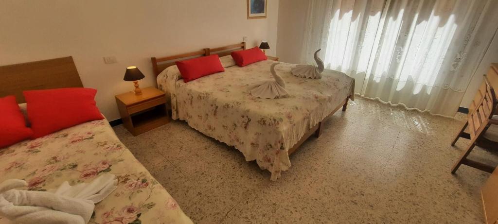 Postel nebo postele na pokoji v ubytování Hotel Dora