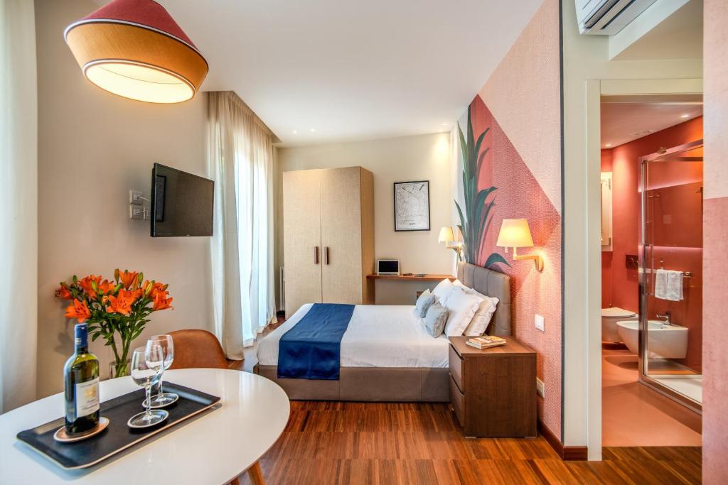 Habitación de hotel con cama y mesa en Milhouse Suites Duomo, en Milán