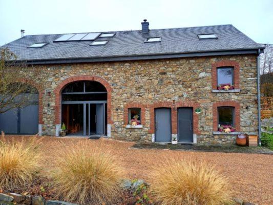 a brick house with windows and a roof at Le Clos du Cerf - Le Sous-bois in Stoumont