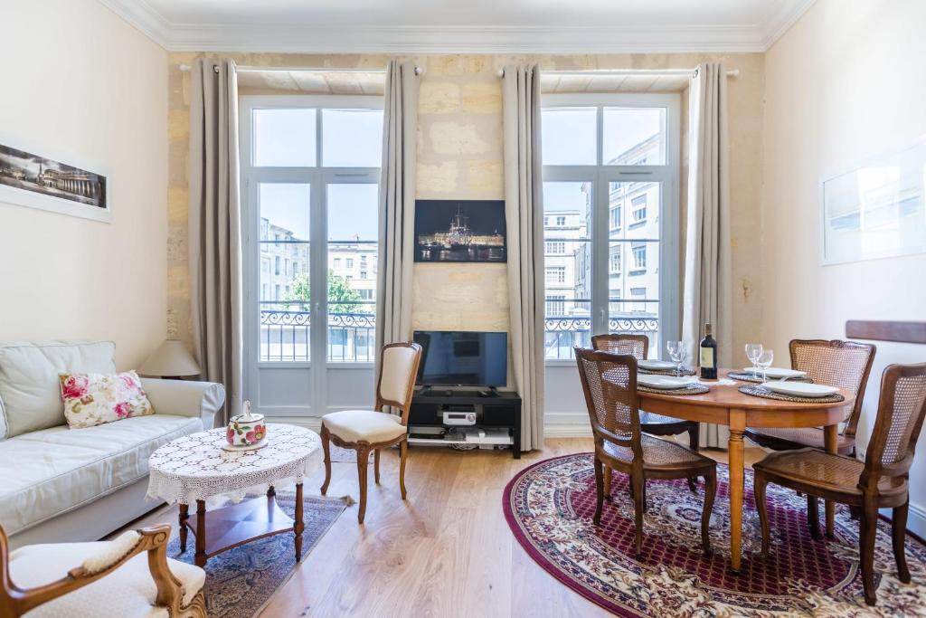 a living room with a couch and a table at GuestReady - Lovely apartment Place de la Bourse in Bordeaux