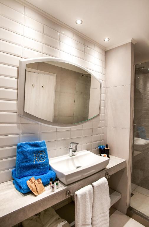 a bathroom with a sink and a mirror at Acrotel Lily Ann Village in Nikiti