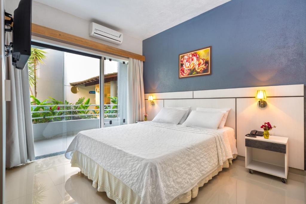Postel nebo postele na pokoji v ubytování Hotel Porto Napolis
