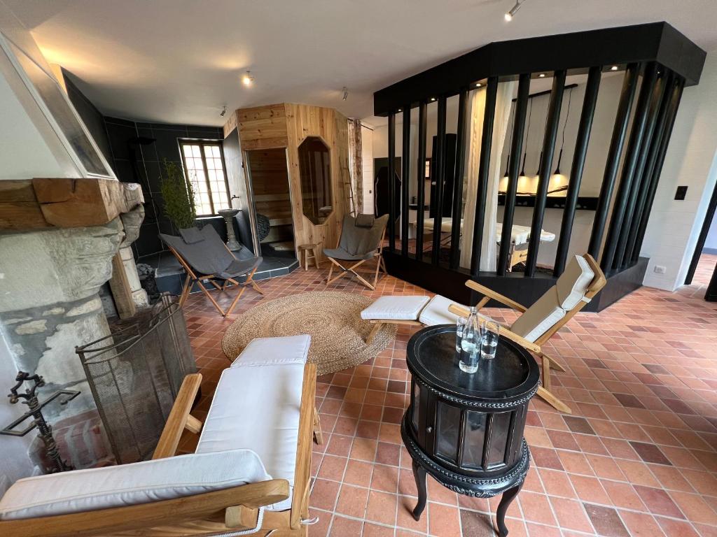 a living room with a table and chairs at Domaine Utah Beach - Le Grand Hard in Sainte-Marie-du-Mont