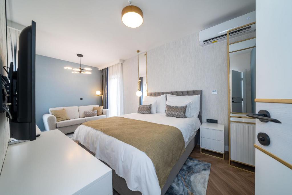 a hotel room with a bed and a couch at Hotel Millennium by Aycon in Budva