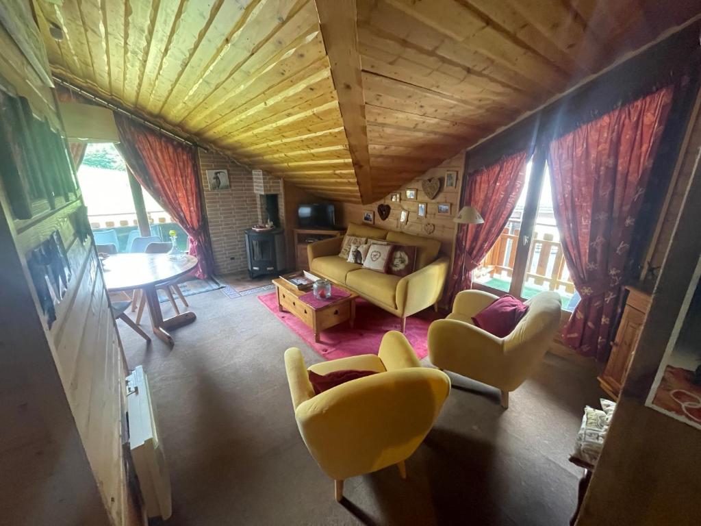 a living room with yellow chairs and a couch at Bel appartement au décor Montagnard - 80m2 in Les Contamines-Montjoie