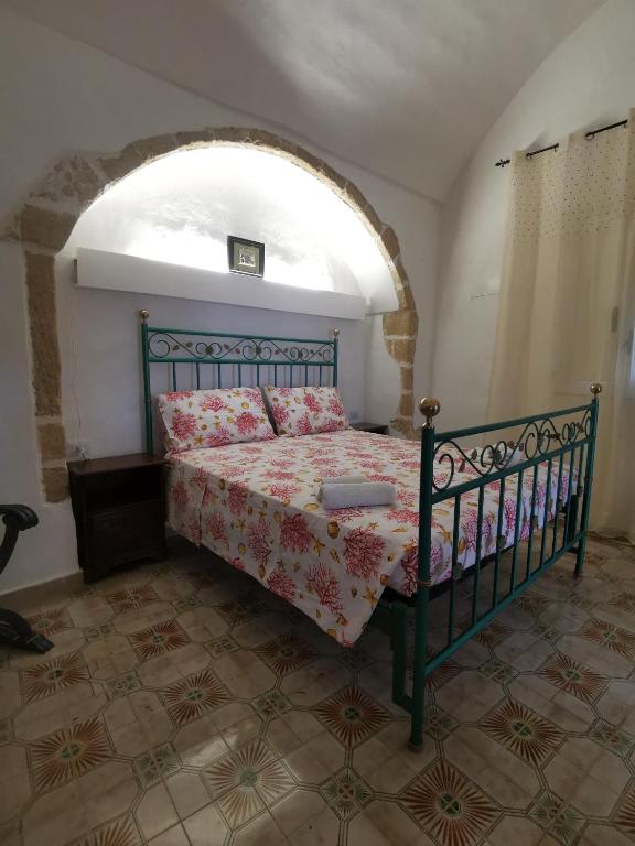 a bedroom with a bed in a room with an arch at La Fontana in Gallipoli