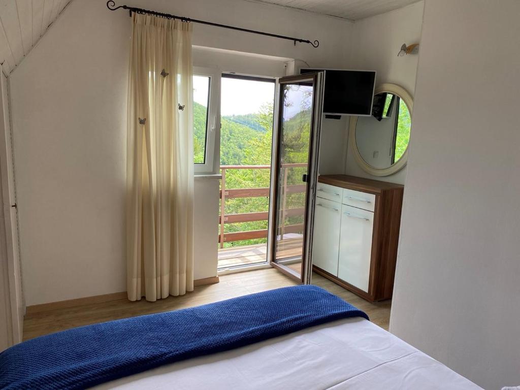 a bedroom with a bed and a large window at Holiday Home Vanda in Bakar