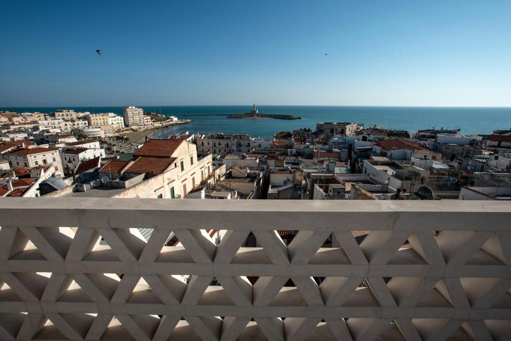 a view of a city from behind a white fence at Dimora Del Dragone in Vieste
