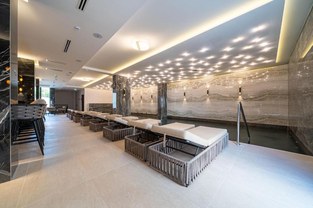 a waiting room with a row of tables and chairs at Hotel Millennium by Aycon in Budva
