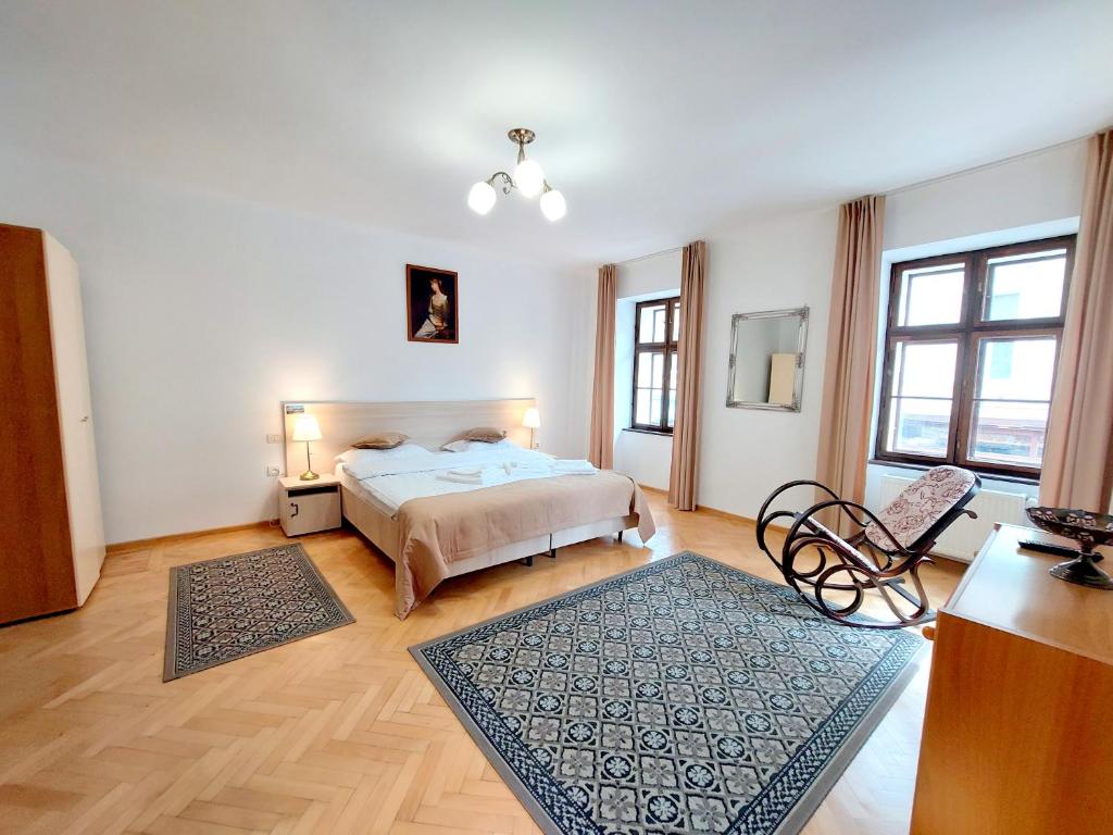 a bedroom with a bed and a table and chairs at Casa Roth in Braşov