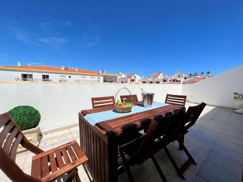 a wooden table and chairs on a patio at Lagos Typical House by Homing in Lagos