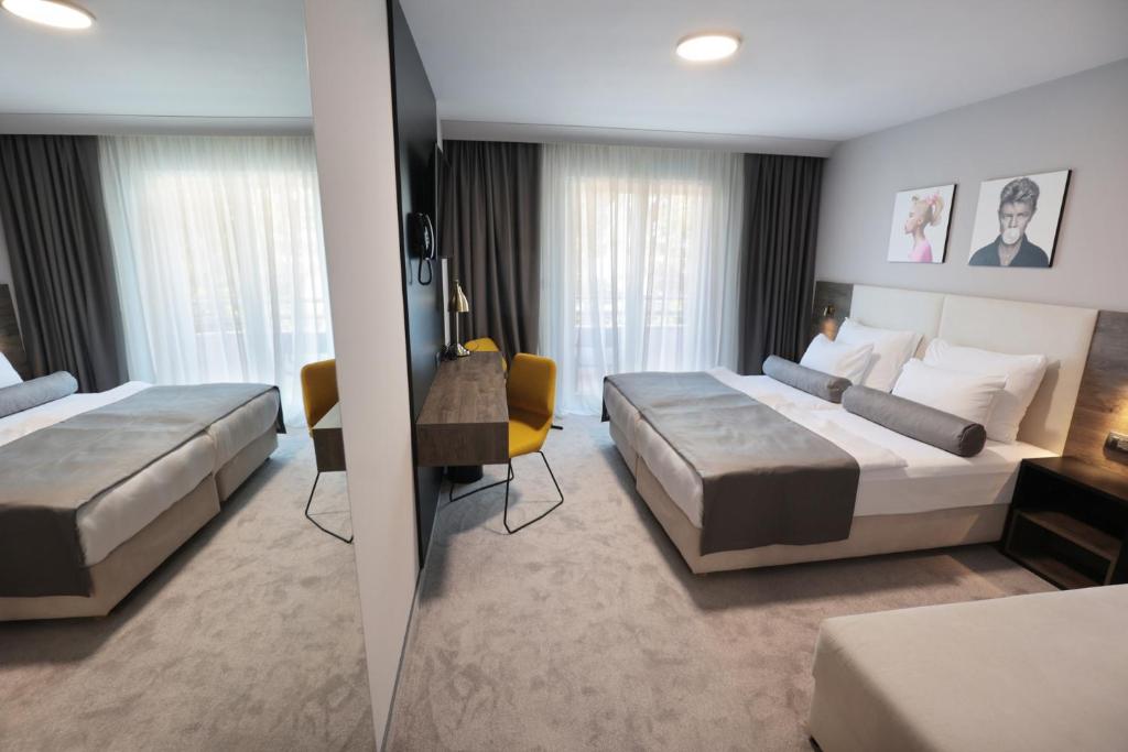 Postel nebo postele na pokoji v ubytování Hotel Milenij