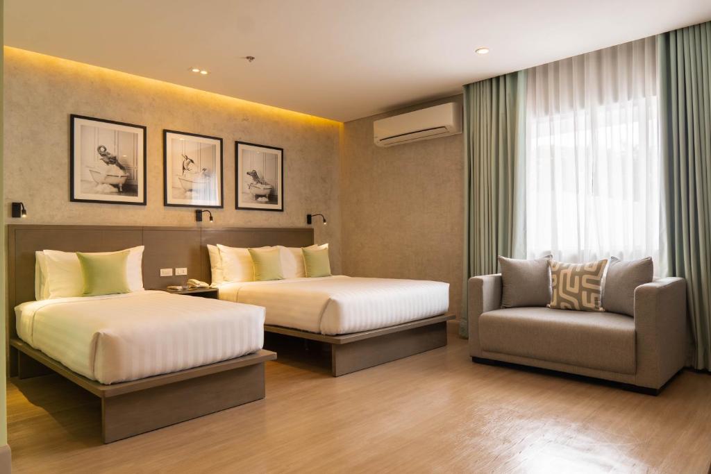 Postel nebo postele na pokoji v ubytování Primeway Suites Cebu