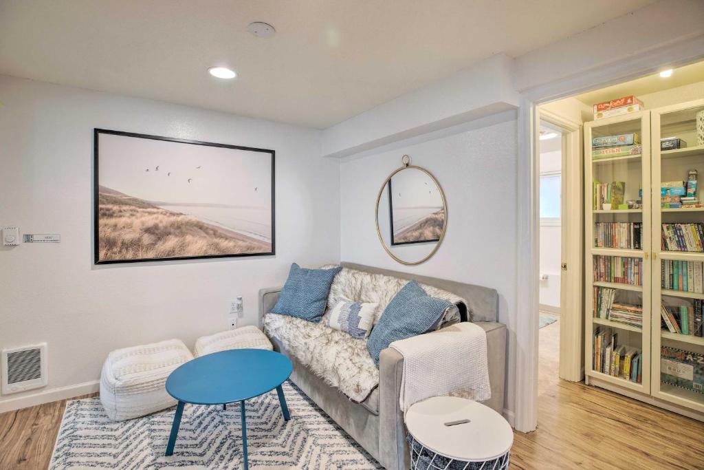 a living room with a couch and a table at Rockaway Beach Condo - Beach Access Nearby! in Rockaway Beach