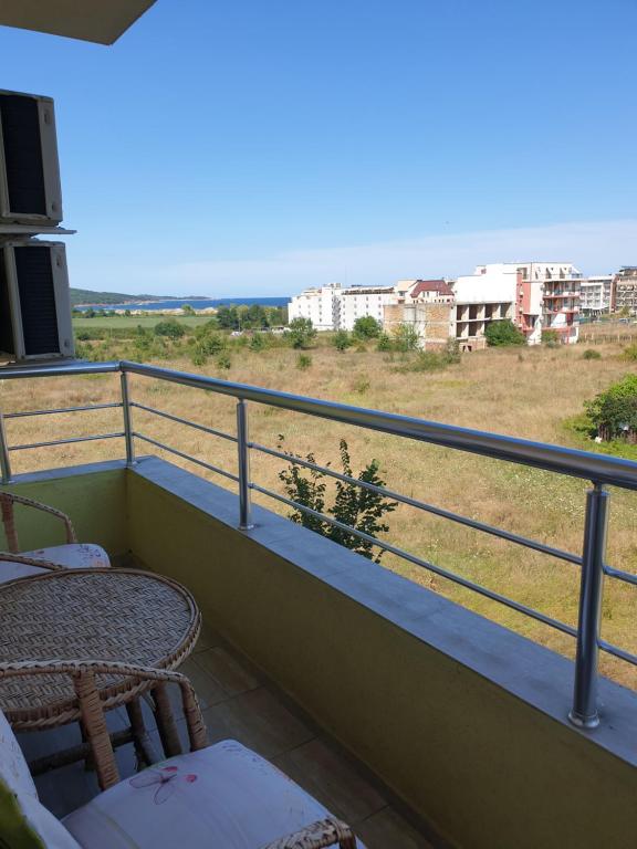 a balcony with a table and chairs and a view at апартамент в Приморско in Primorsko