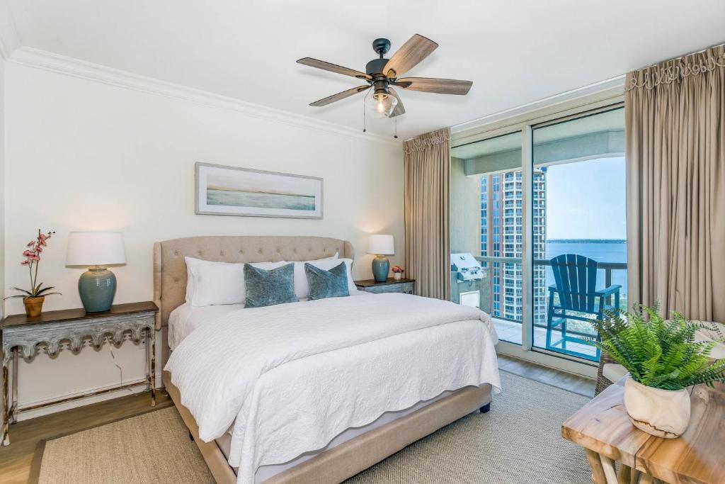 a bedroom with a bed with a view of the ocean at 3 Portofino 1406 in Pensacola Beach