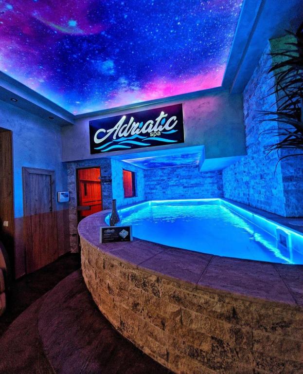 a swimming pool in a room with a star ceiling at Adriatic Spa in Novi Sad