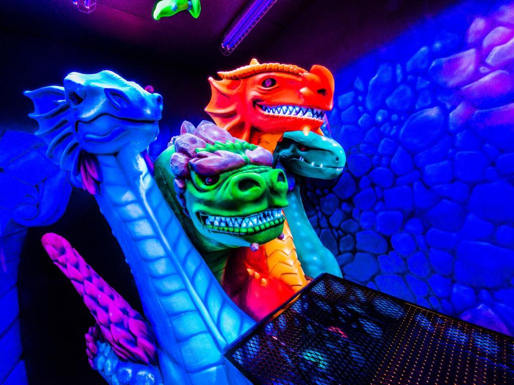 two colorful dinosaur statues sitting next to each other at West Edmonton Mall Inn in Edmonton