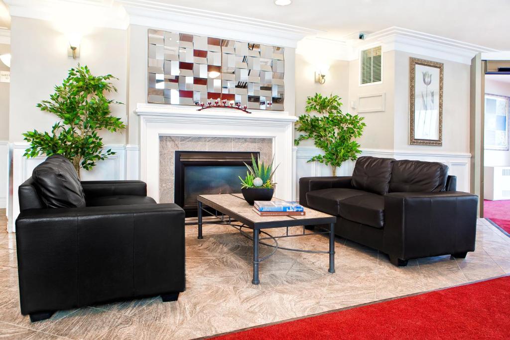 a living room with two couches and a fireplace at West Edmonton Mall Inn in Edmonton