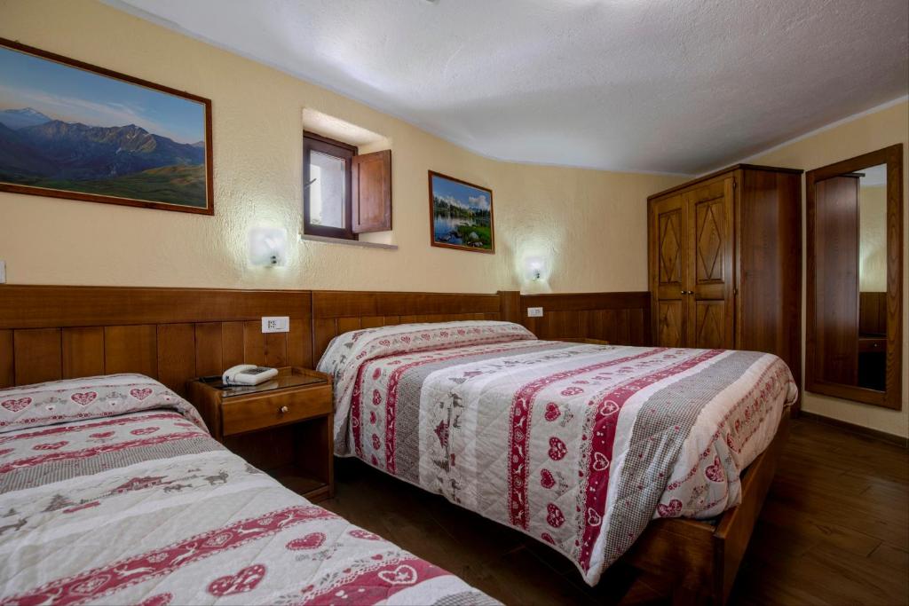 Postel nebo postele na pokoji v ubytování Hotel Cecchin