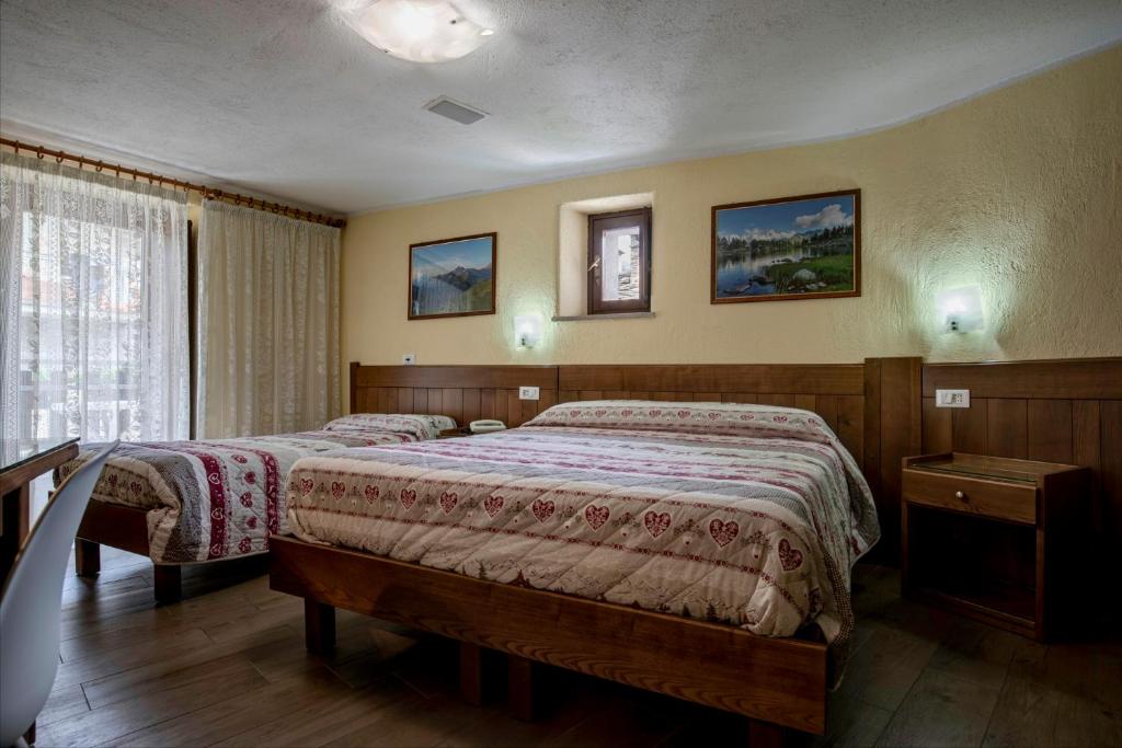 Postel nebo postele na pokoji v ubytování Hotel Cecchin