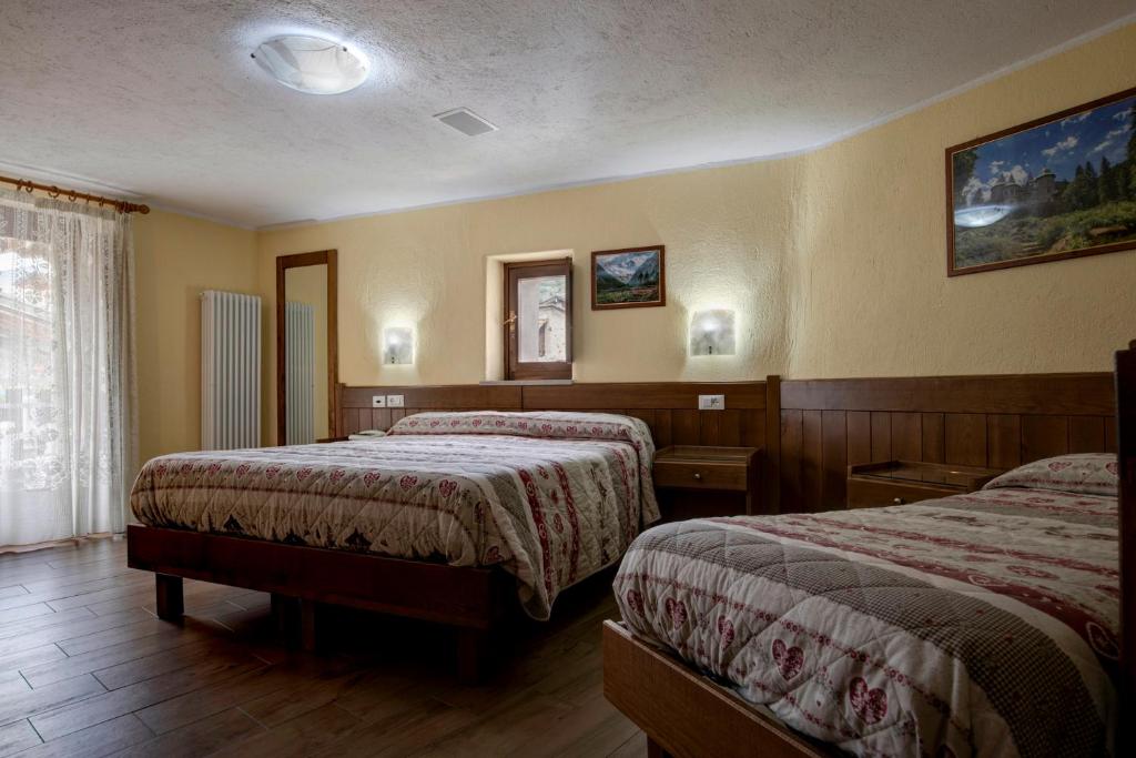 Postel nebo postele na pokoji v ubytování Hotel Cecchin