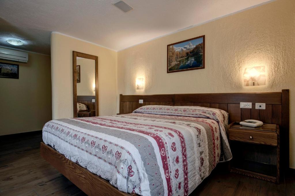 Postel nebo postele na pokoji v ubytování Hotel Cecchin