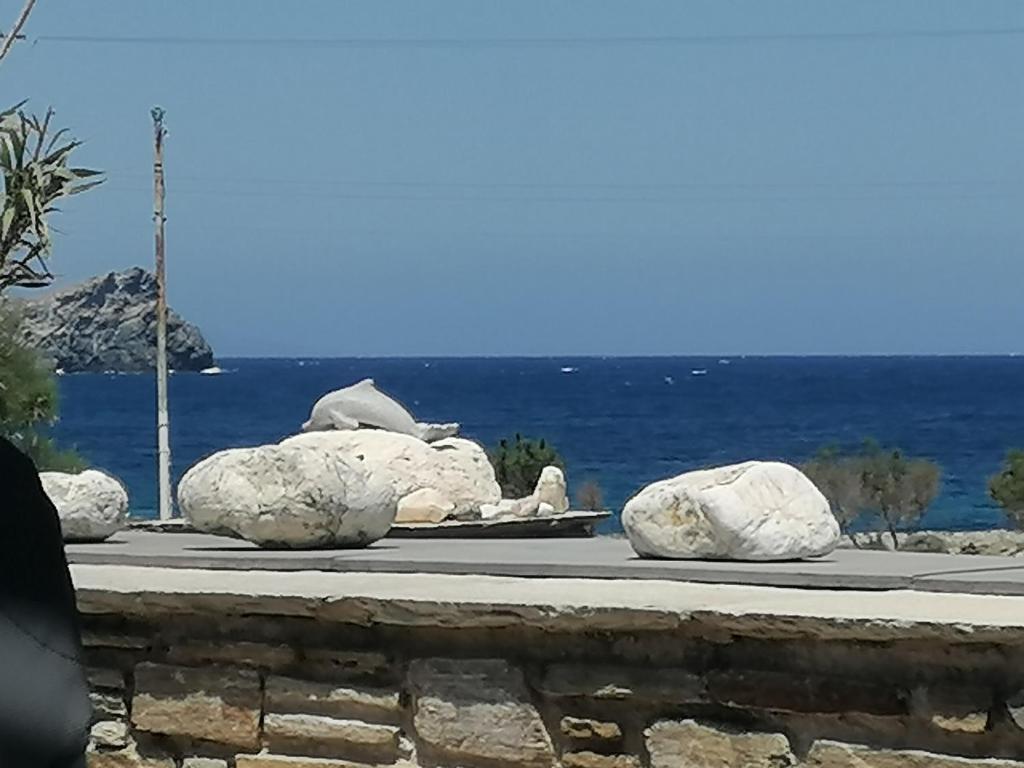 a group of rocks on a sidewalk near the ocean at Beautiful house near the sea in Kollimpithra