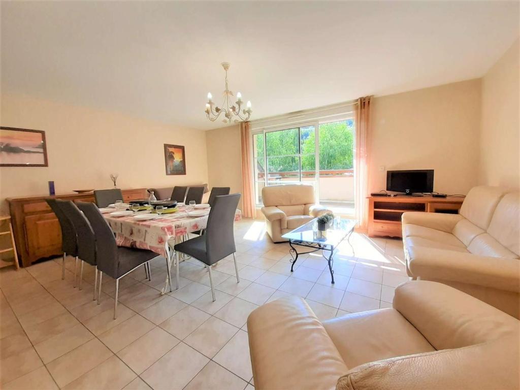 a living room with a table and chairs and a couch at Appartement Saint-Lary-Soulan, 4 pièces, 9 personnes - FR-1-457-181 in Saint-Lary-Soulan