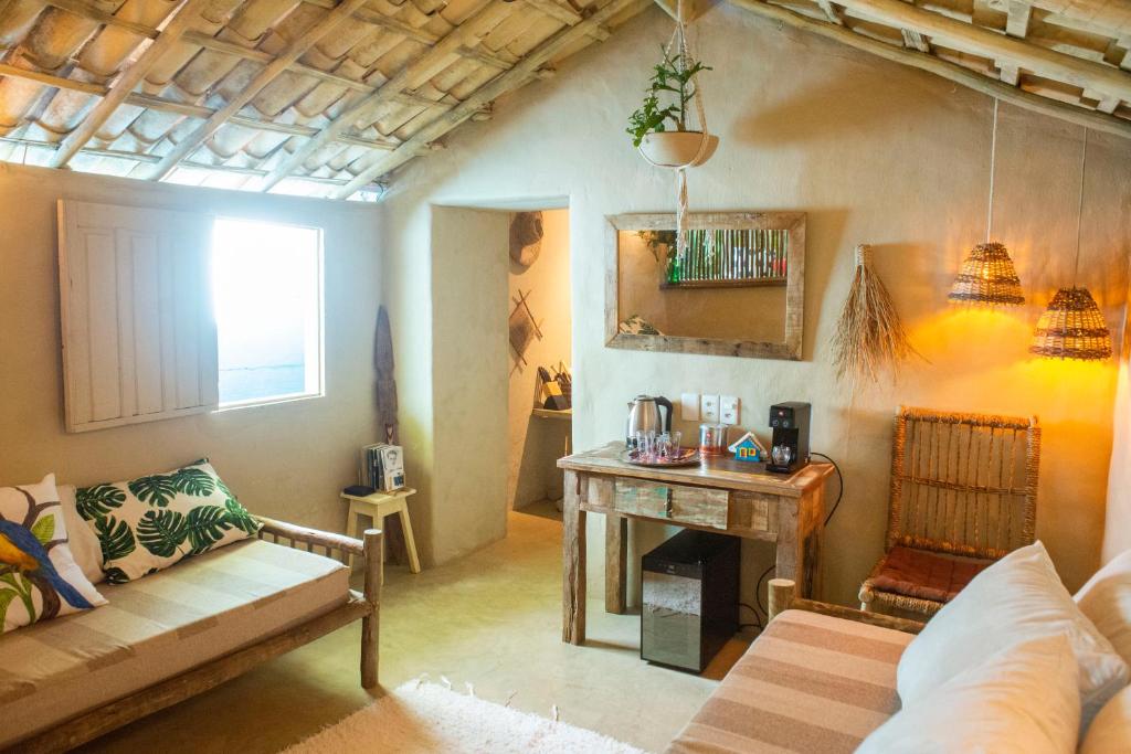 a living room with a couch and a table at Petit Quadrado no melhor lugar de Trancoso in Trancoso