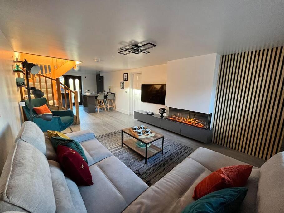 a living room with a couch and a fireplace at Camellia Cottage in Camborne