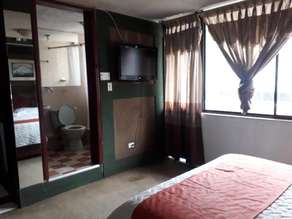 Postel nebo postele na pokoji v ubytování Hotel Tungurahua