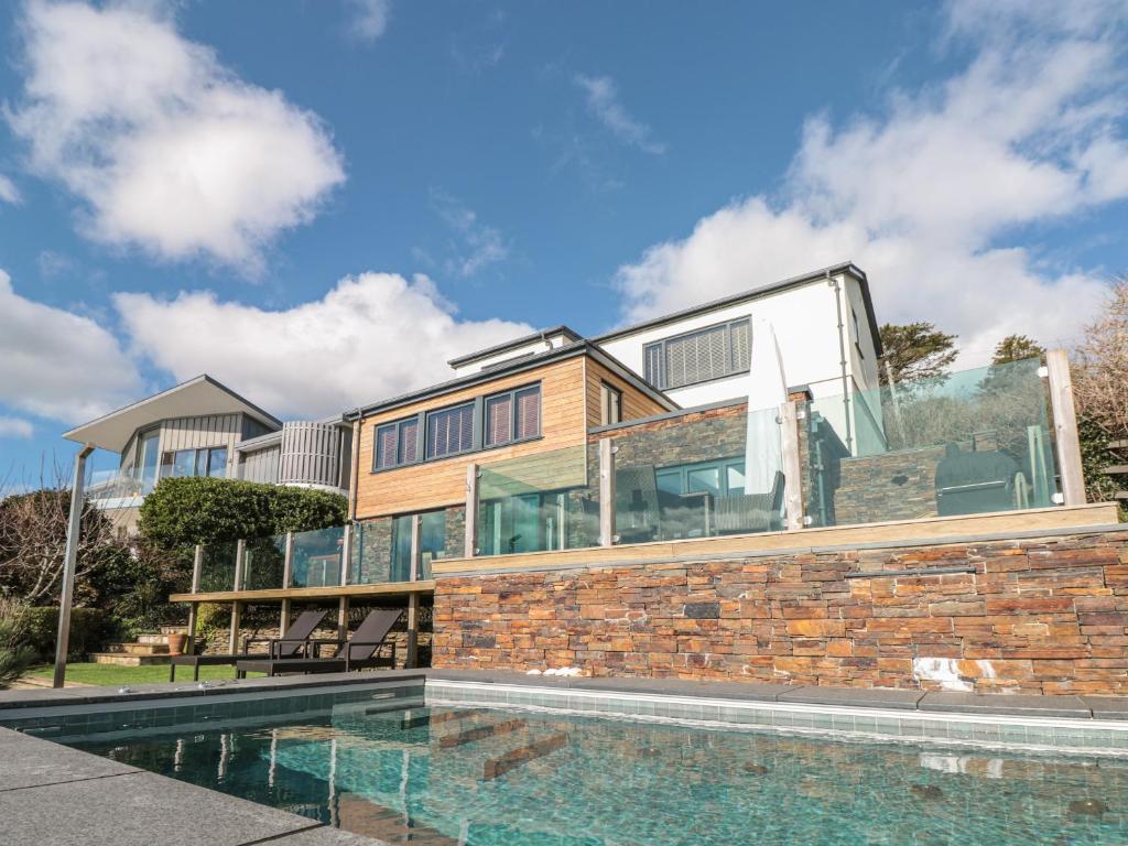 una casa con piscina frente a ella en The Gulls en Dartmouth