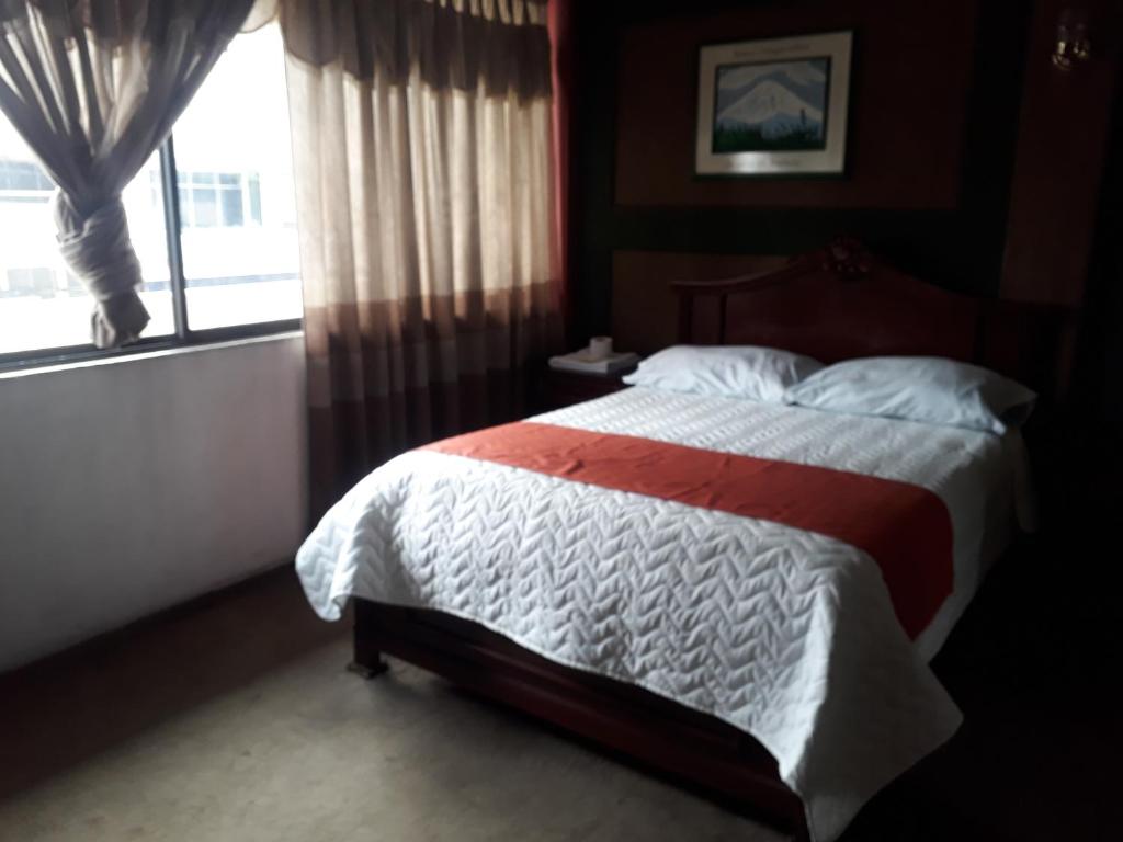 Postel nebo postele na pokoji v ubytování Hotel Tungurahua