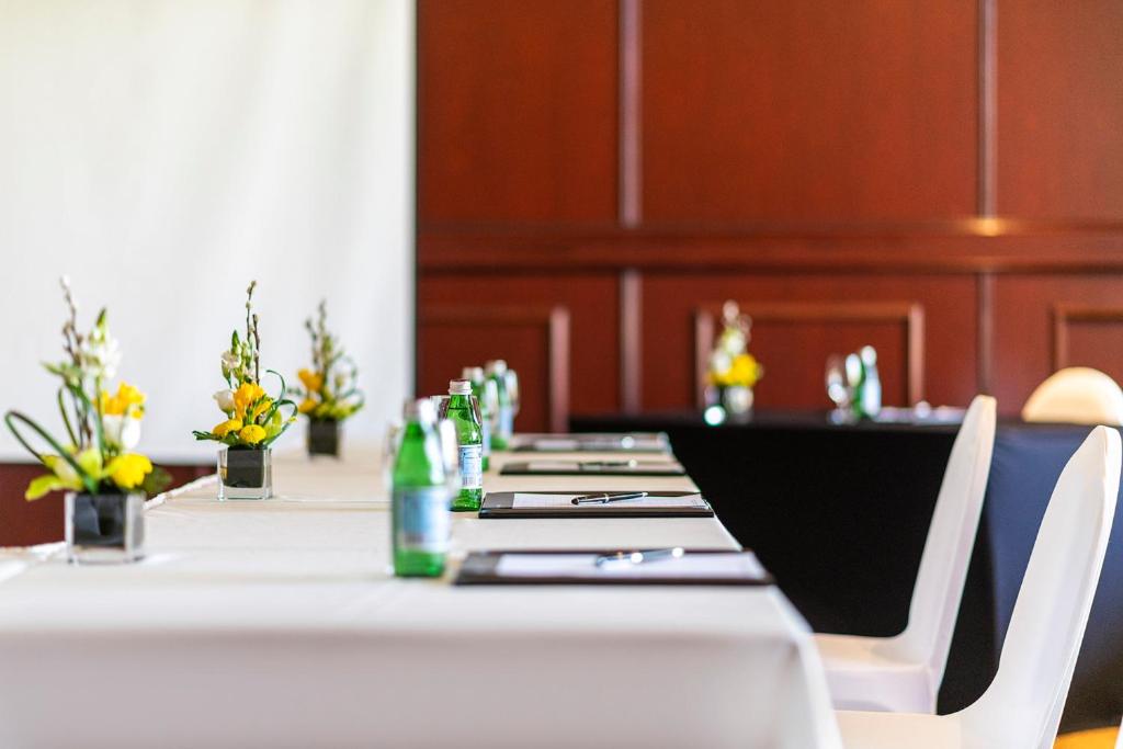 a long table with chairs and bottles on it at InterContinental Muscat by IHG in Muscat