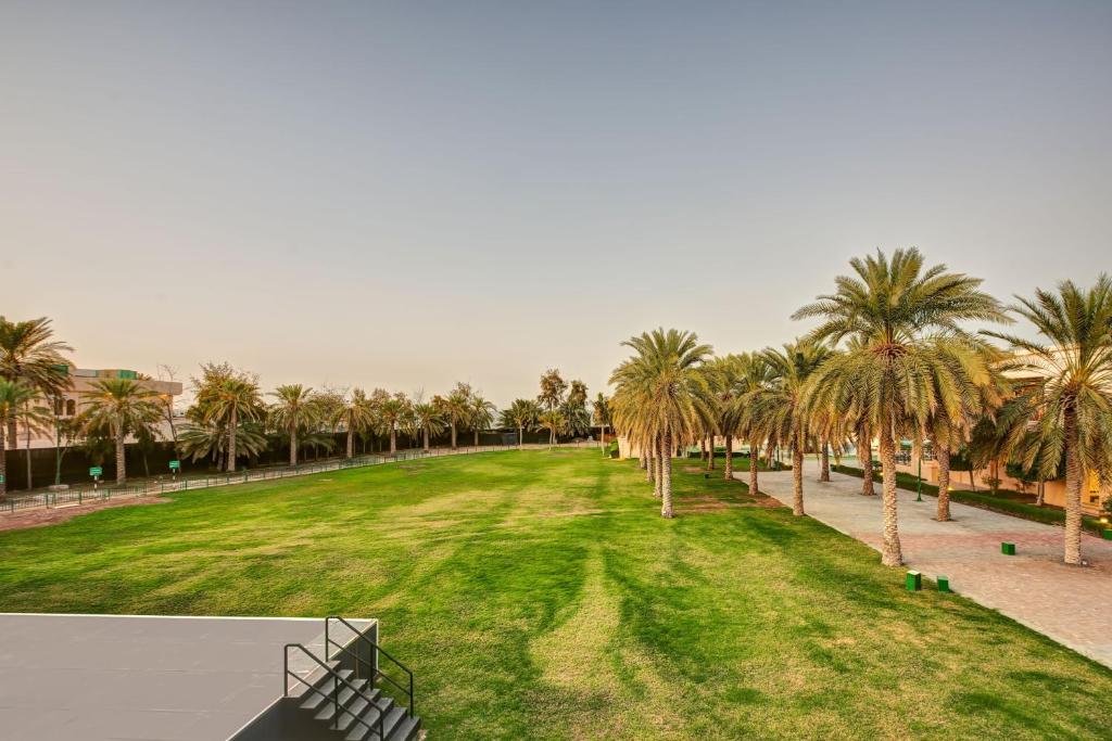 a view of a park with palm trees at InterContinental Muscat by IHG in Muscat