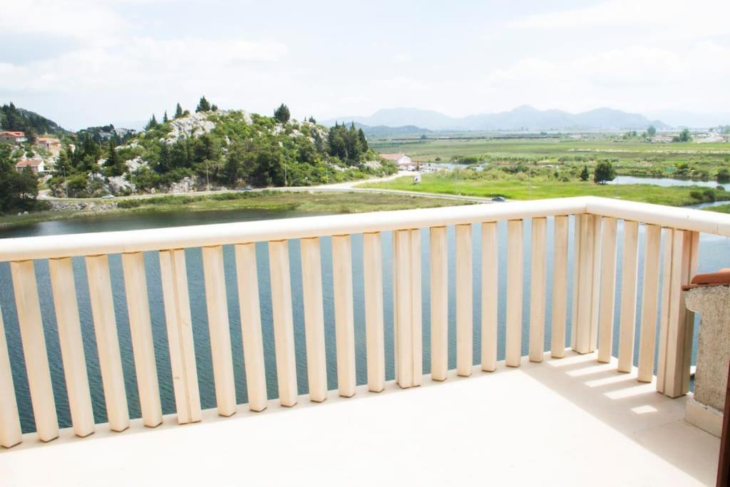 a balcony with a view of a river and mountains at Comfortable and beautiful apartment in Ploče