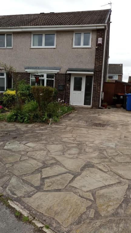 a house with a stone driveway in front of it at Beeston House in Thornton