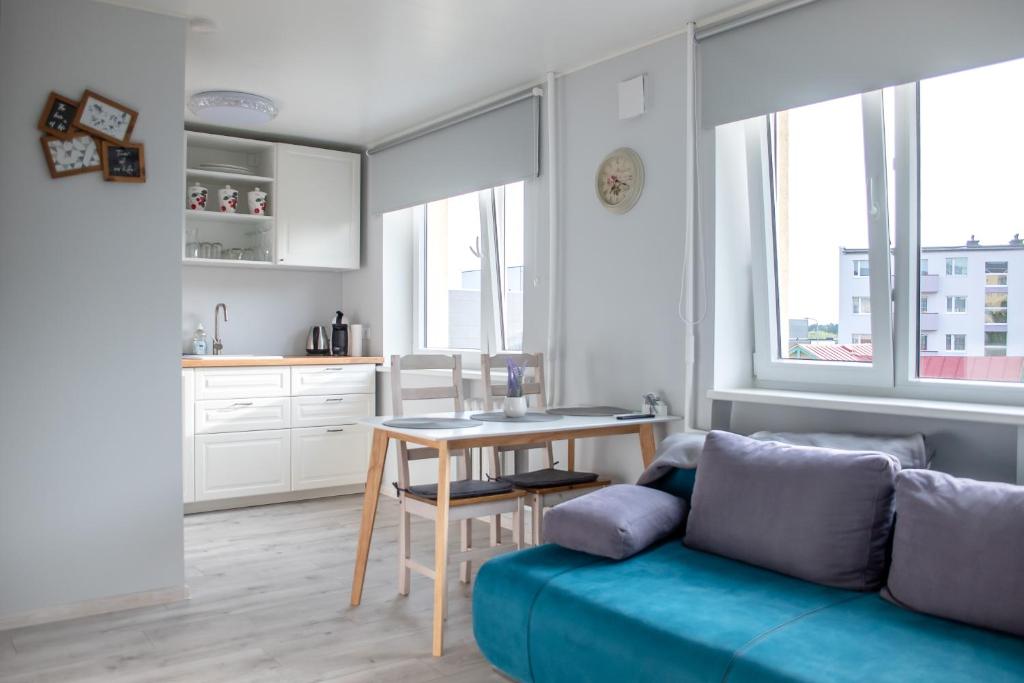 a living room with a couch and a table at Roosi apartment Haapsalu in Haapsalu