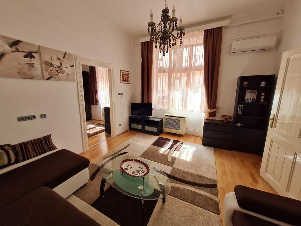 a living room with a couch and a glass table at Marble Apartment -near Buda castle in Budapest