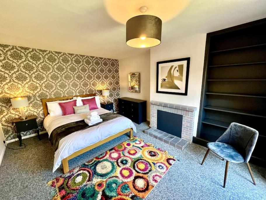 a bedroom with a bed and a fireplace at Seven Limes in Southwell
