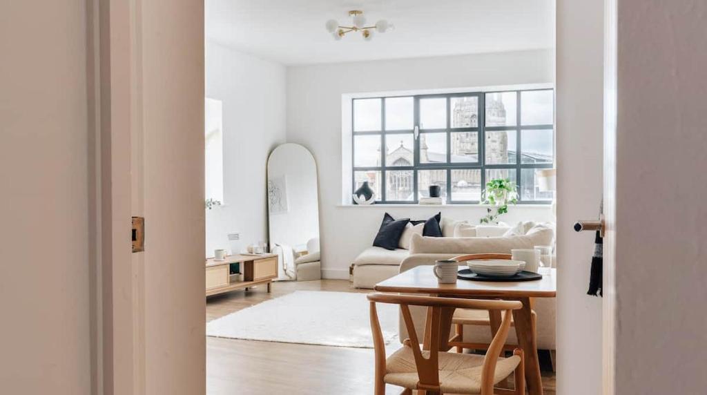a white living room with a table and a couch at BRAND NEW apartment - Stay in the heart of the city in Norwich
