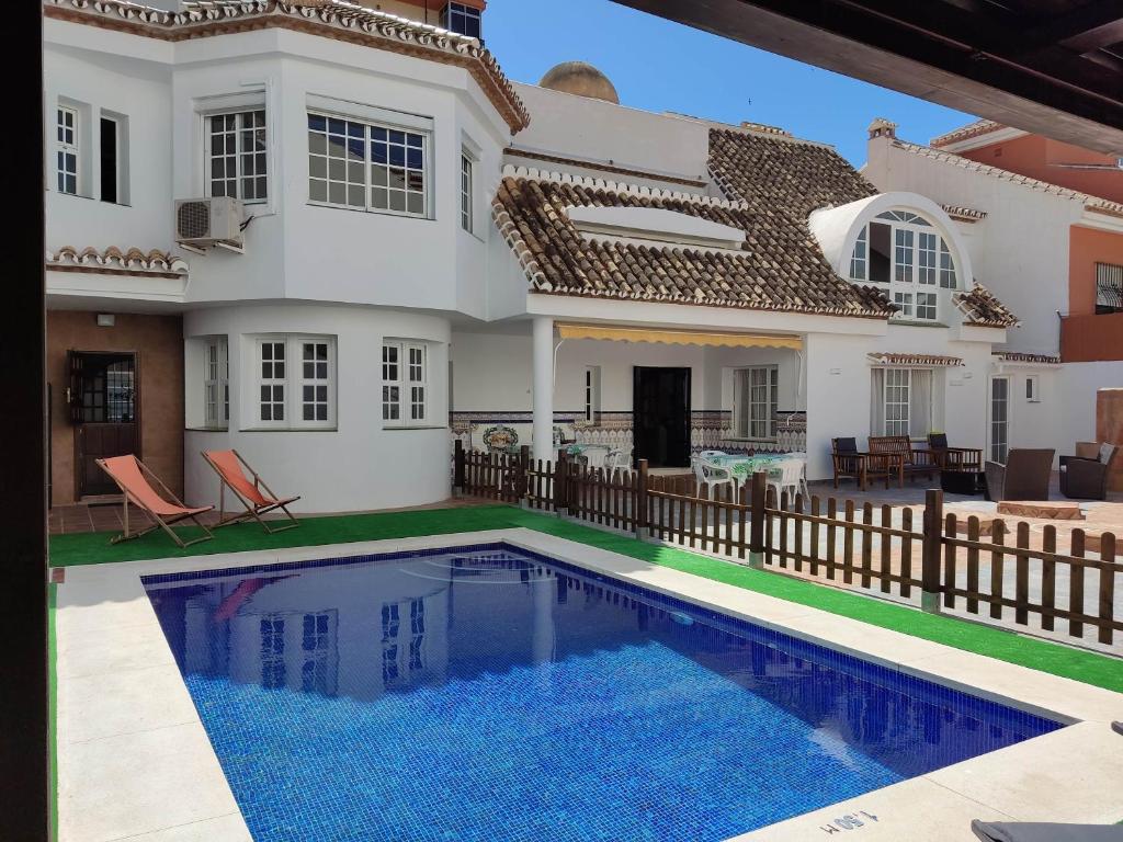 a house with a swimming pool in front of it at Villa Casa Vega Fuengirola in Fuengirola