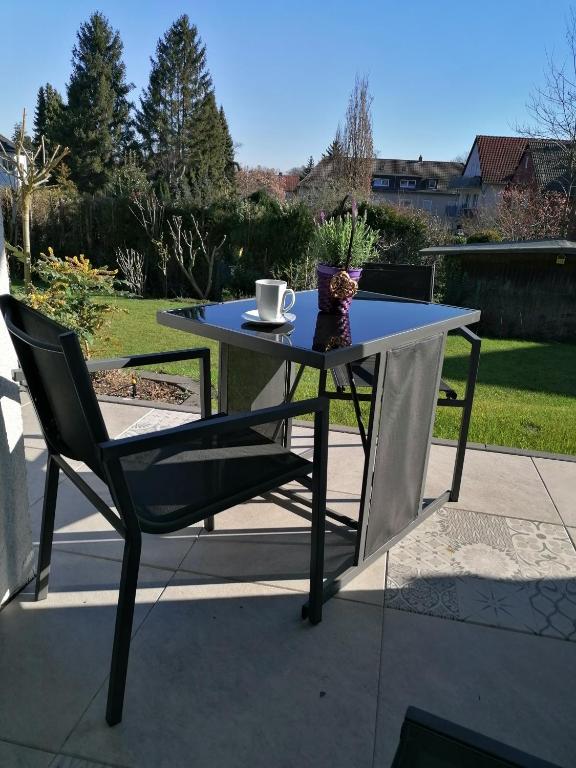 a table and a chair sitting on a patio at Dohlennest, helle moderne Wohnung für 4 Personen in Mülheim an der Ruhr