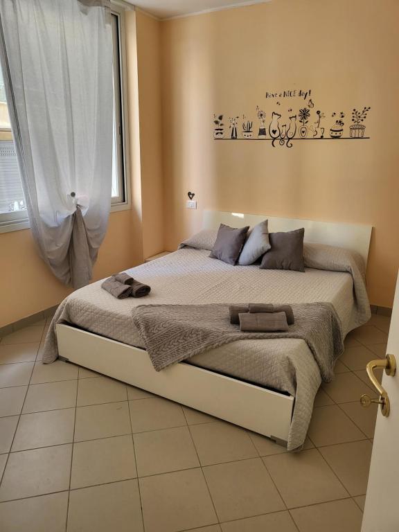 a bedroom with a large bed with a window at King house in Sanremo