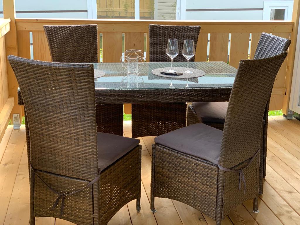 a table with chairs and wine glasses on a deck at Chalet Max II in Helming