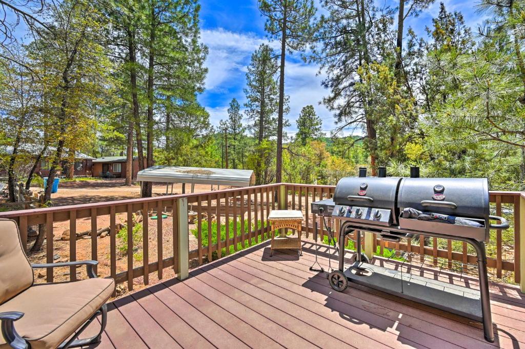 a grill on a wooden deck with a picnic table at Near Hiking Trails Woodsy Pine Cabin with Fire Pit in Pine