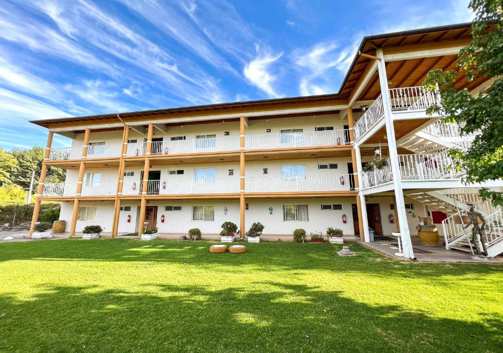 una vista exterior de un gran edificio con patio en Hotel El Almendro, en Paine