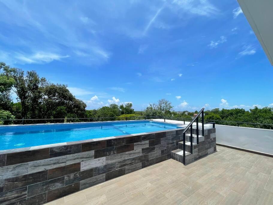 a swimming pool on top of a house at Beautiful Modern House Private Pool in Cancún